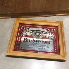 a framed plaque with the name budweiser on it