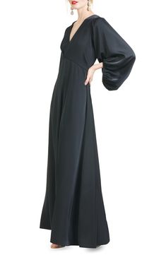 Billowed sleeves add a dramatic touch to this satin gown styled with a sweeping skirt. 62" length V-neck Long sleeves Lined 100% polyester Dry clean Imported Knee Length Evening Dress, Empire Waist Gown, Sachin Babi, Evening Dresses With Sleeves, Black Satin Dress, Long Balloons, Dress Home, Satin Gown, Gowns With Sleeves