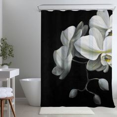 a black and white shower curtain with flowers on it