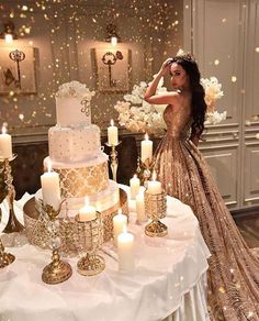 a woman standing next to a table with candles