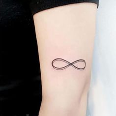 a woman's arm with an infinite symbol tattoo on it