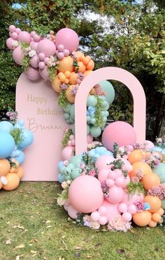 an image of balloons and flowers in the grass