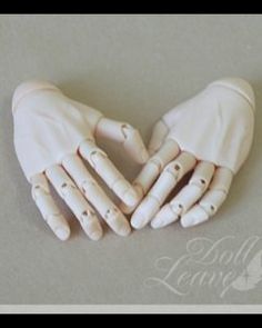 two hands that are made out of clay