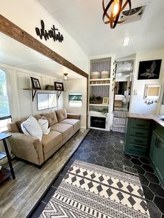 a living room filled with furniture next to a kitchen and an open concept floor plan