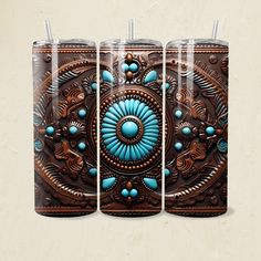 three glass tumblers with blue and brown designs on the front one has a straw in it