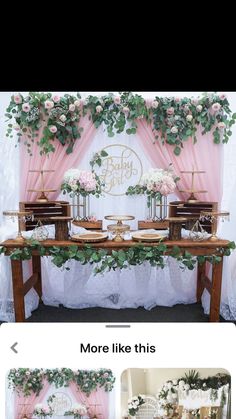 the wedding cake table is decorated with flowers and greenery