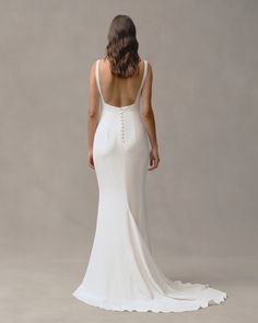 a woman in a white wedding dress back view