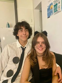 a man and woman are dressed up as cats