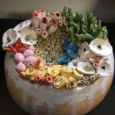 there is a vase with many different things in it that are made out of clay