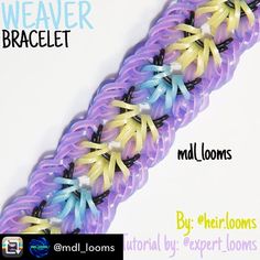 a close up of a purple and yellow loom bracelet with flowers on it's end