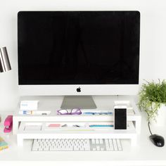 an apple computer sitting on top of a white desk