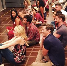 a group of people sitting on the floor together