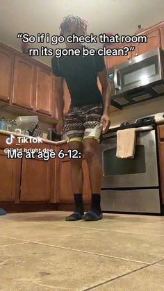 a man standing in the middle of a kitchen