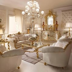 a fancy living room with white couches and gold trimmings, chandeliers and lamps