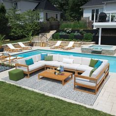 an outdoor living area with couches and tables next to a swimming pool in the backyard