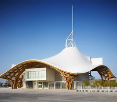 a large white building with an unusual roof