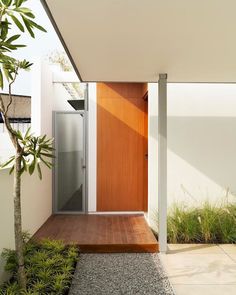 an entrance to a modern house with wooden doors