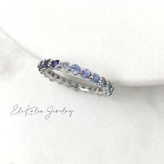 This beautiful minimalist stackable full eternity ring features natural blue or pink sapphire from a gentle pastel tone to vivid saturated color. Made to Order. Ships within 3-4 weeks. - Stone info: natural blue or pink sapphire, 2.5mm round brilliant cut - Total ct weight: approx. 2ctw - Finish: white or rose - Made in 14 karat gold. - Stamp with 14K. Ombre Sapphire Ring, Sapphire Stackable Ring, Wishbone Necklace Gold, Sapphire Eternity Ring, Celestial Ring, Sapphire Rings, Full Eternity Ring, Ringe Gold, Textured Ring