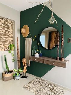 a green and white room with a mirror, plants and other items on the wall