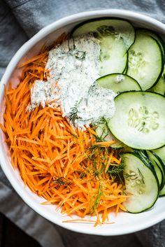 cucumbers, carrots and cheese in a white bowl