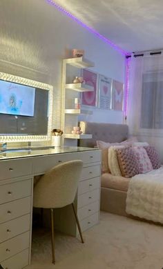 a bedroom with a bed, desk and television on the wall next to a window