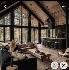 a living room filled with furniture and lots of windows next to a kitchen counter top