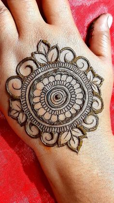 a woman's hand with a henna tattoo on it