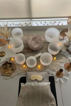 a table topped with lots of white dishes