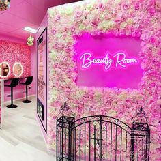 the beauty room is decorated in pink and white flowers, along with an iron gate