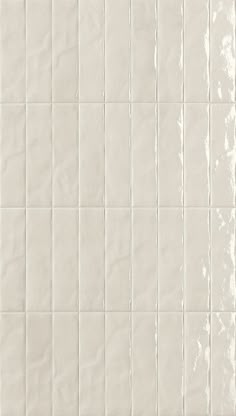 a white tiled wall with lines on it