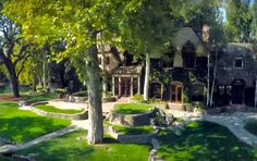 a large house surrounded by lush green trees