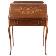 an antique wooden desk with drawers on one side and floral design on the other end