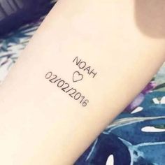 a woman with a tattoo on her arm that says noah, love 2012 - 2016