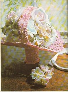 a bouquet of flowers sitting on top of a table next to a pair of scissors