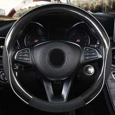 the interior of a car with steering wheel cover