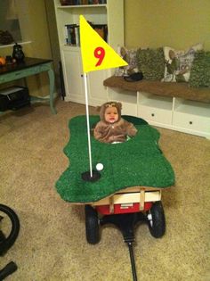 a child's toy golf cart with a flag on top and a stuffed animal in the middle