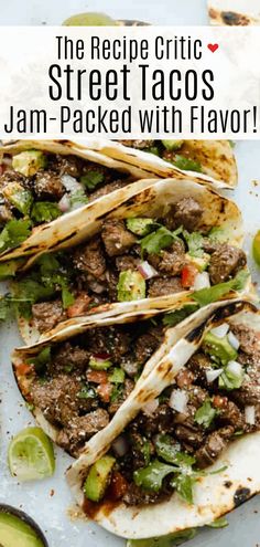 three steak tacos with avocado, cilantro and lime on top