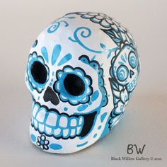 a blue and white sugar skull sitting on top of a table