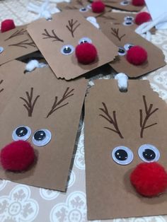 paper bags with reindeer faces on them and red pom - poms around the eyes