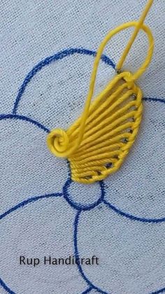 a close up of a yellow object on a blue and white cloth with circles around it