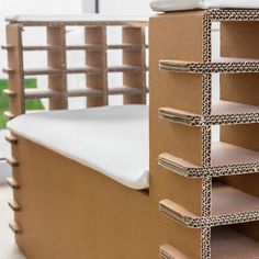 a bed made out of cardboard and some shelves