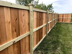 a wooden fence is shown in the grass