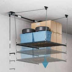 two blue plastic containers are hanging from the ceiling above some shelves with wheels on them