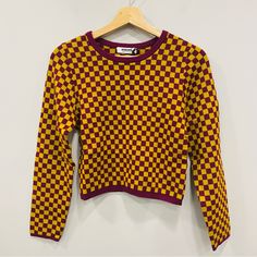 Daydreamer Nwt M Fig Check Plaid Fitted Cropped Pullover Crewneck Soft Stretch Sweater Brand New With Tags: No Flaws Size: Medium Pit To Pit: 15.5” Length: 18” Sleeve Length: 22.5” Wine Purple With Gold Checkered All-Over Print Ribbed Knit Neckline And Hem Long Sleeves Jewel Tones Super Soft, Stretchy And Cozy Viscose / Polyester / Nylon Dry Clean Made In China Questions? Leave A Comment Below! 9 Oz. Trendy Purple Crew Neck Sweater, Purple Knit Long Sleeve Top, Purple Long Sleeve Knit Top, Purple Knit Crew Neck Top, Fitted Purple Crew Neck Sweater, Retro Purple Winter Tops, Retro Purple Long Sleeve Sweater, Cropped Pullover, Sweater Brands