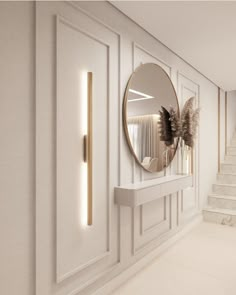 a white hallway with a round mirror on the wall