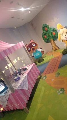 the children's play area is decorated in pink, green and yellow colors with an animal theme