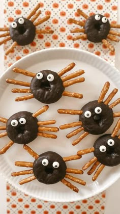 chocolate spider pretzels with googly eyes on a plate