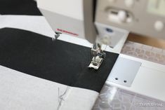 the sewing machine is working on the fabric