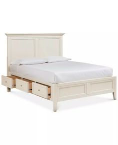 a white bed with two drawers underneath it