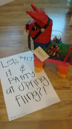 a paper horse and sign on the floor